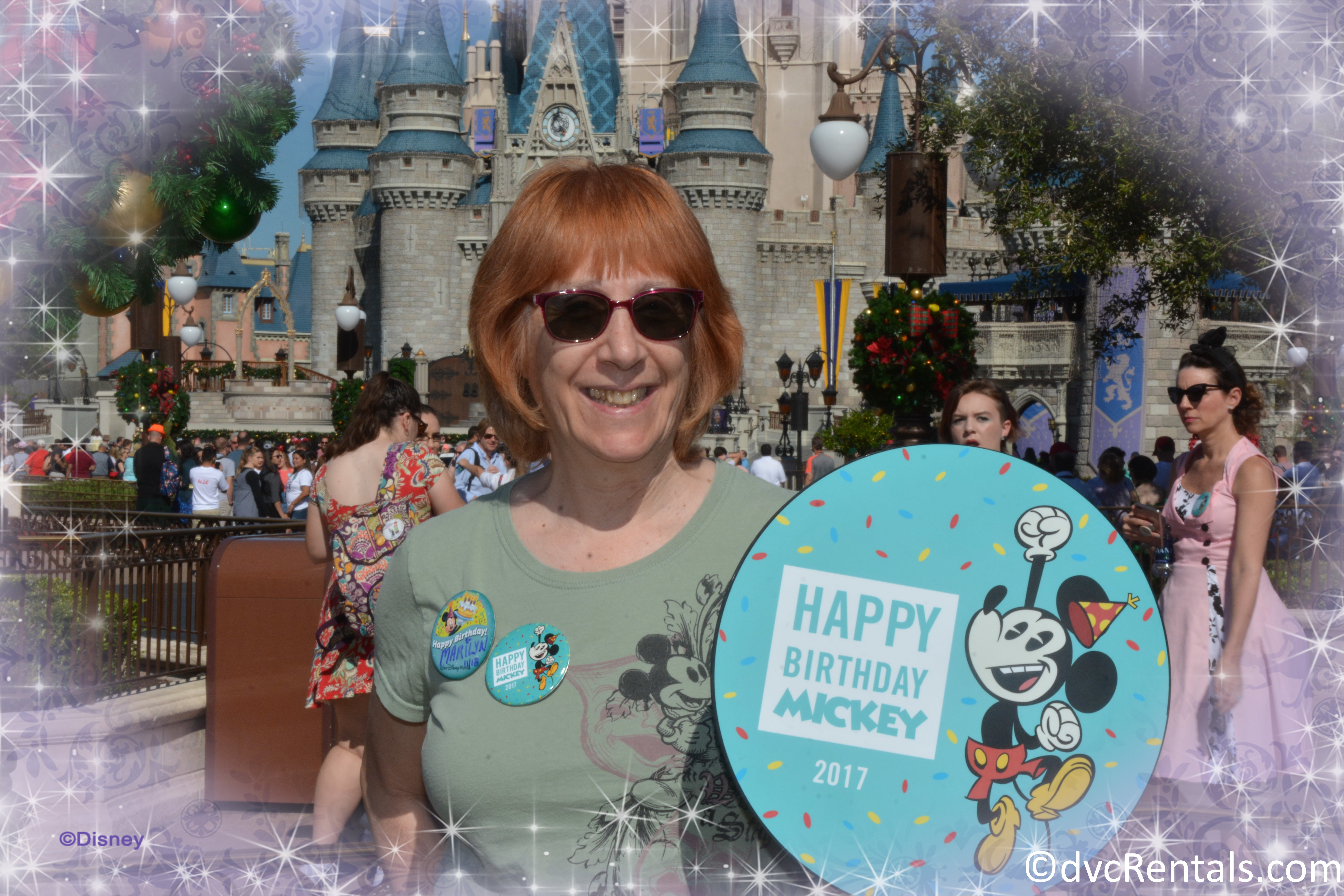 Marilyn with Happy birthday Mickey Sign in front of the Magic Kingdom