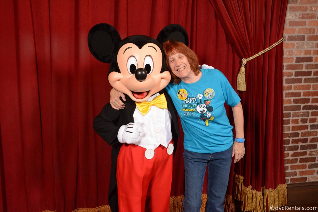 Marilyn posing for a picture with Mickey Mouse