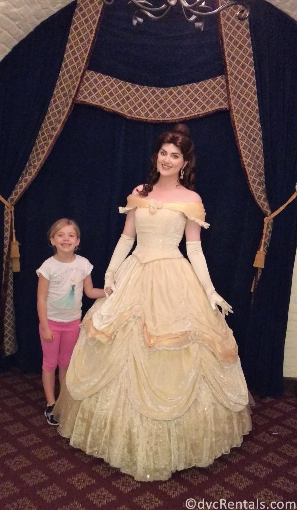 Belle and young guest posing for a picture at Akershus Royal Banquet Hall