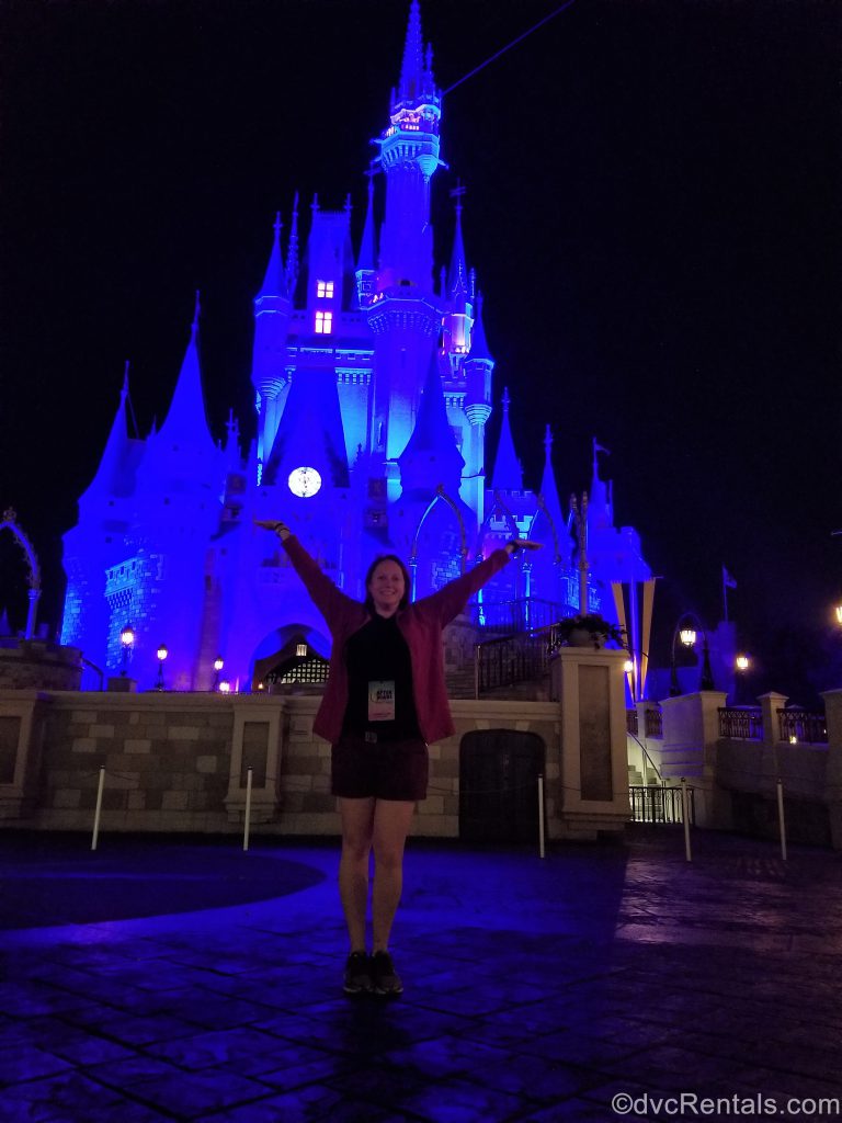 Team Member Kelly standing in front of Cinderella Castle at night with no other people around