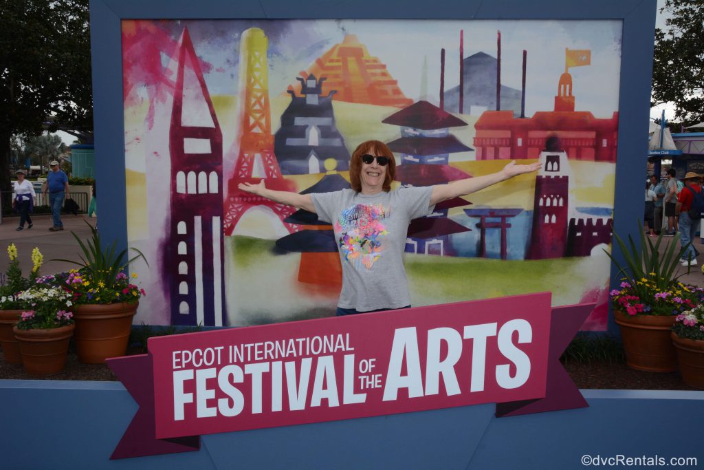 Festival of the arts sign with guests standing in it as part of the artwork