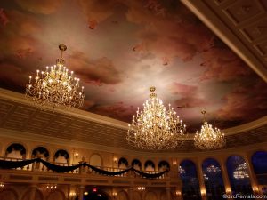 ceiling with mural and chandelier in the main dining room at Be Our Guest