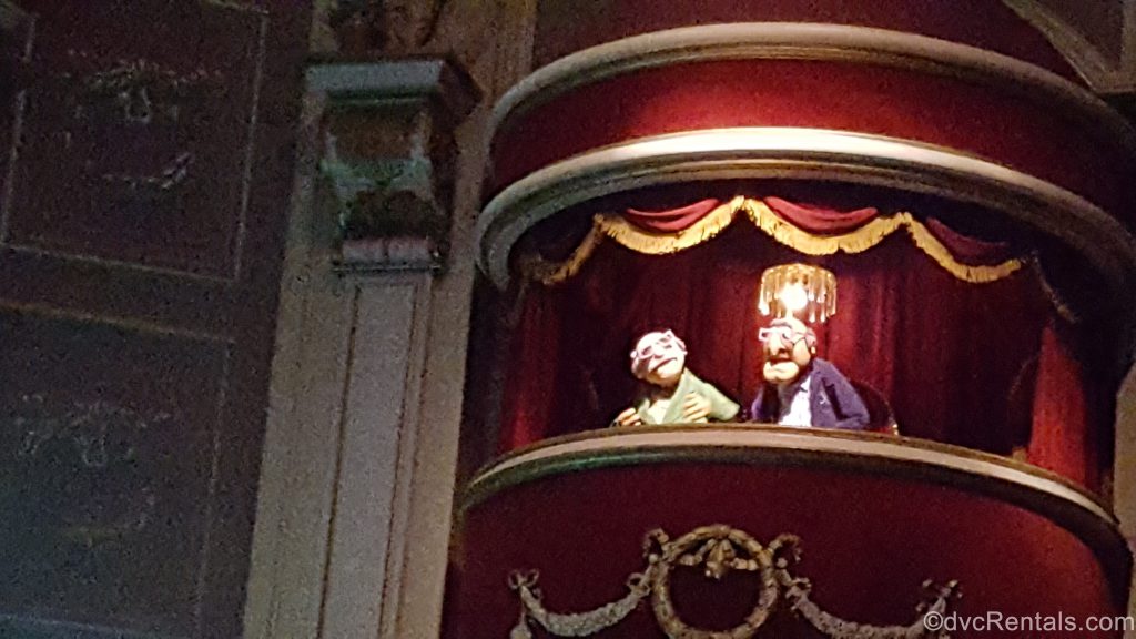 Statler and Waldorf sitting in theater seats at Muppet Theater