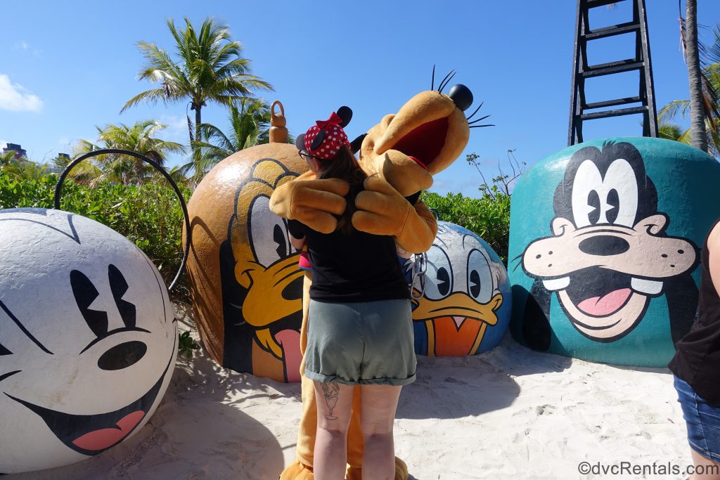 Pluto with Team Member Carly at Castaway Cay