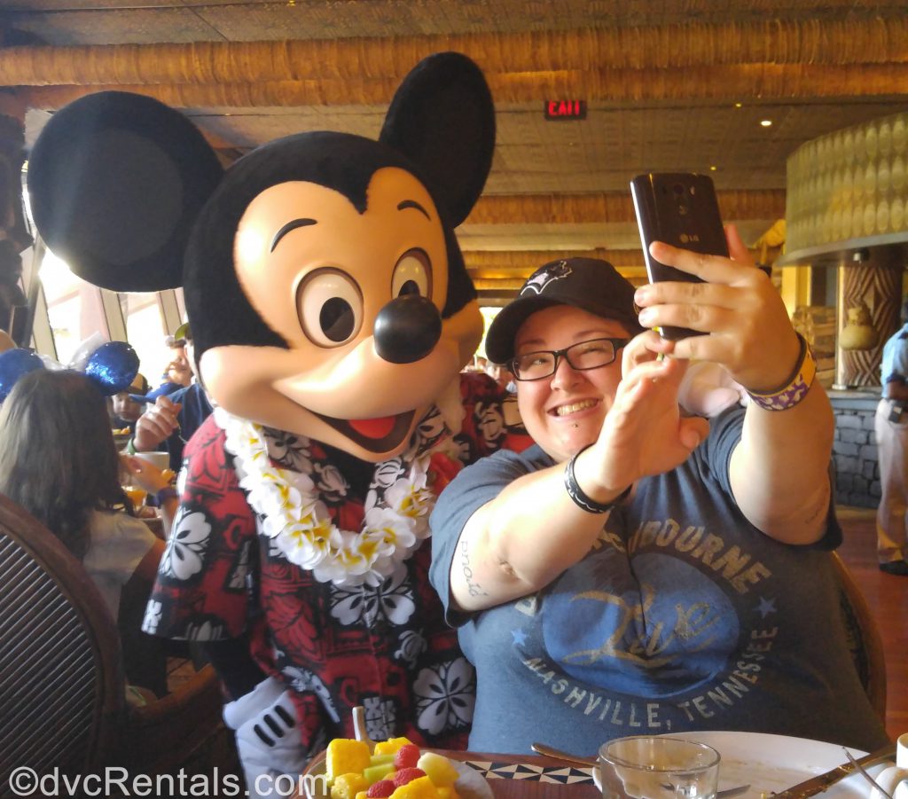 Team Member Lindsay posing for a picture with Mickey Mouse