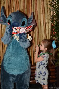 Guest posing for picture with Stitch