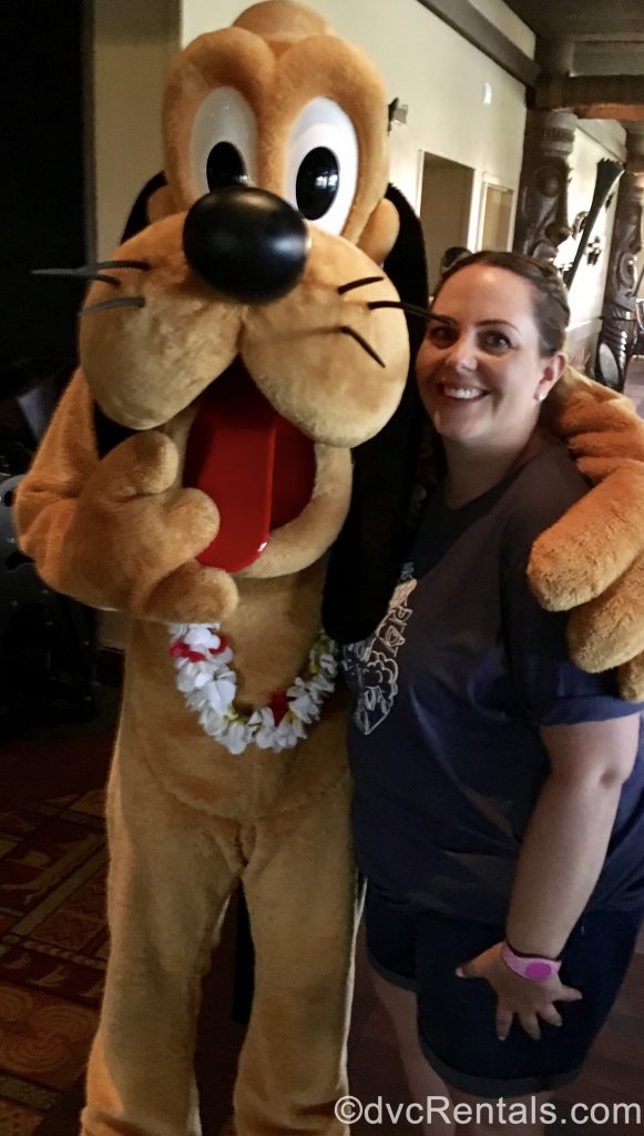 Team Member Stacy posing for a picture with Pluto