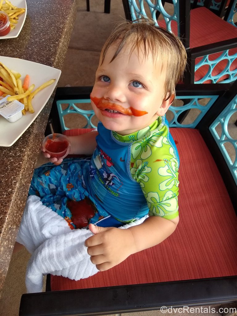 Guest Blogger Kara’s son eating dinner by the pool