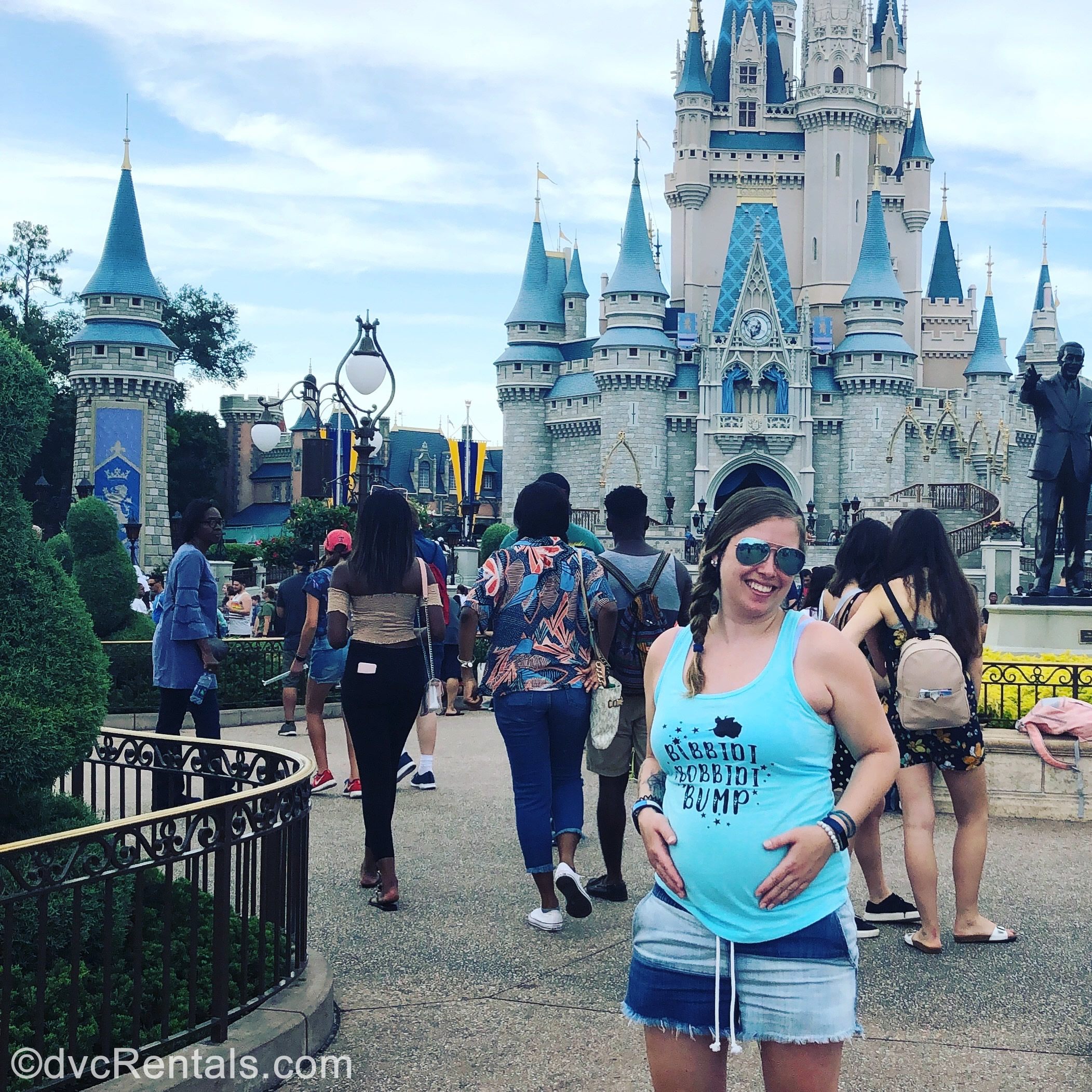 Team Member Ashley J. standing in front of Cinderella Castle