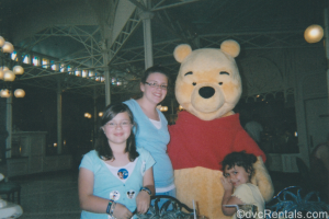 Team Member Alyssa and her family with Winnie the Pooh at Crystal Palace