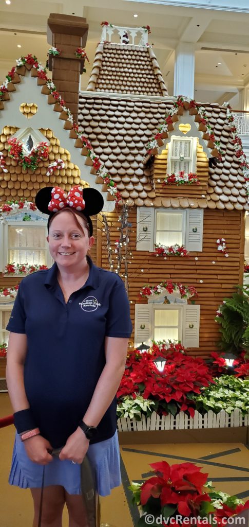 Team member Kelly in front of the Gingerbread house at Disney’s Grand Floridian