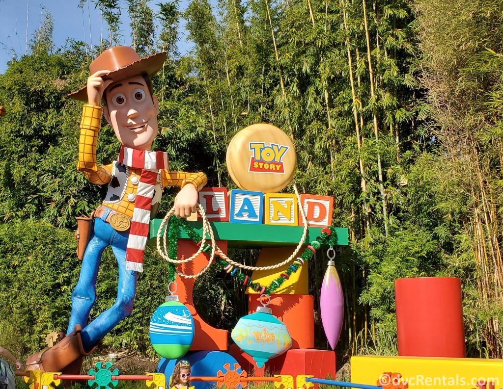 Toy Story Land Sign with Woody wearing a Christmas scarf