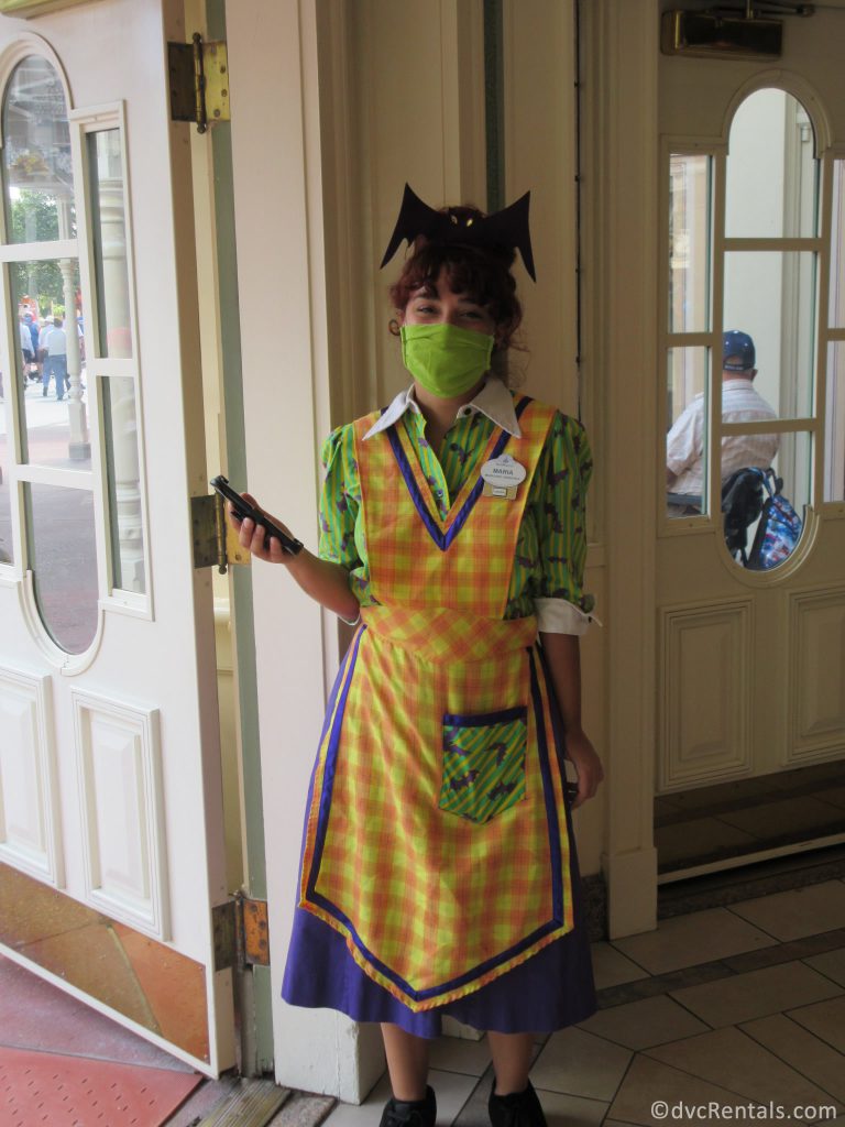 Disney Cast Member dressed up in a Halloween themed uniform