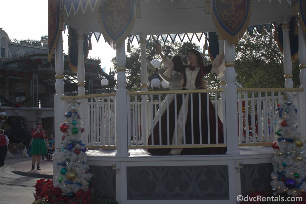 Princesses dressed in holiday clothes at the Magic Kingdom