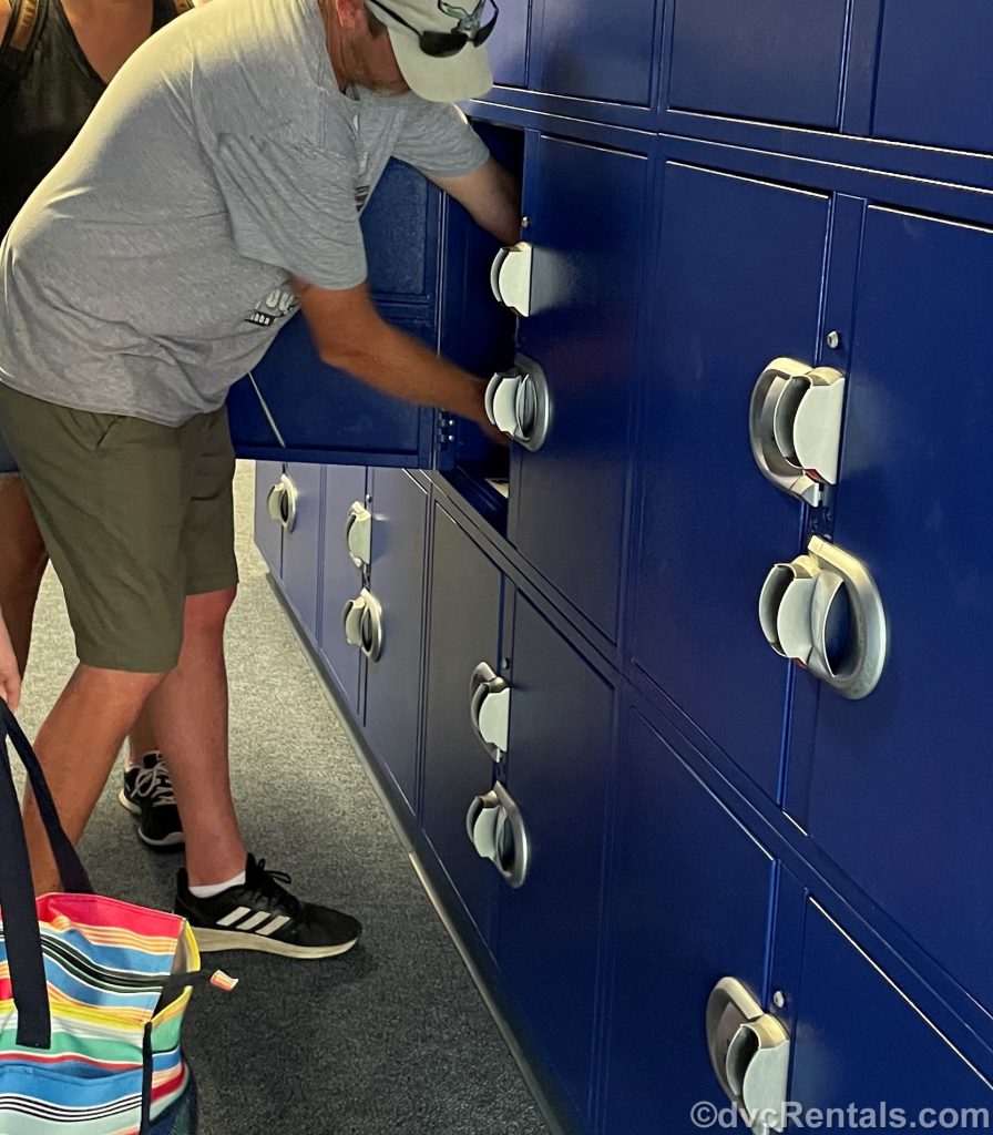 guests placing items into a locker at WDW