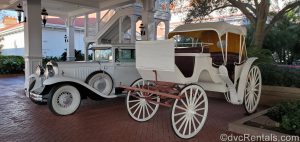Classic car and carriage in front of the Grand Floridian Resort and Spa