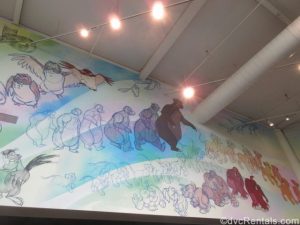 sketches of Disney characters on the walls a the Animation Experience