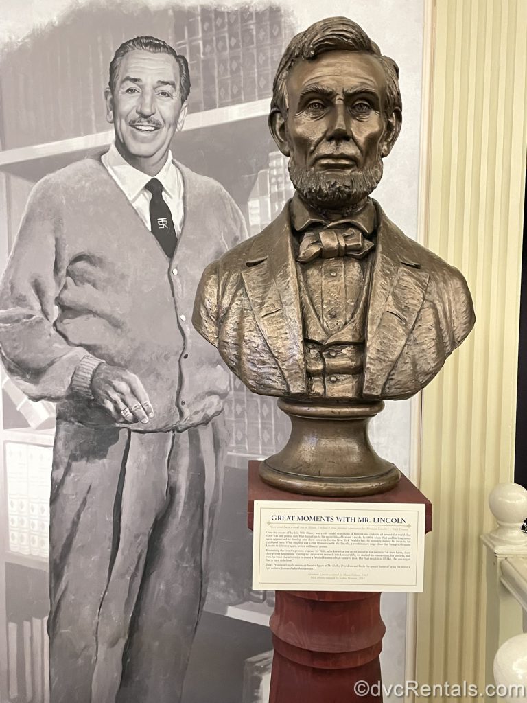 picture of Walt Disney next to a sculpture of President Abraham Lincoln