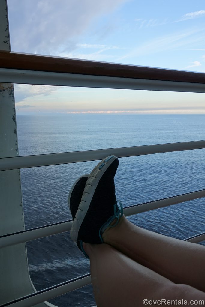 feet up on balcony rail while the Disney Dream is sailing the seas