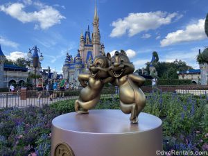 Chip and Dale Gold statues with Cinderella Castle in the background