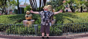eam Member Stephen standing with 50th anniversary gold statues at Disney’s Hollywood Studios