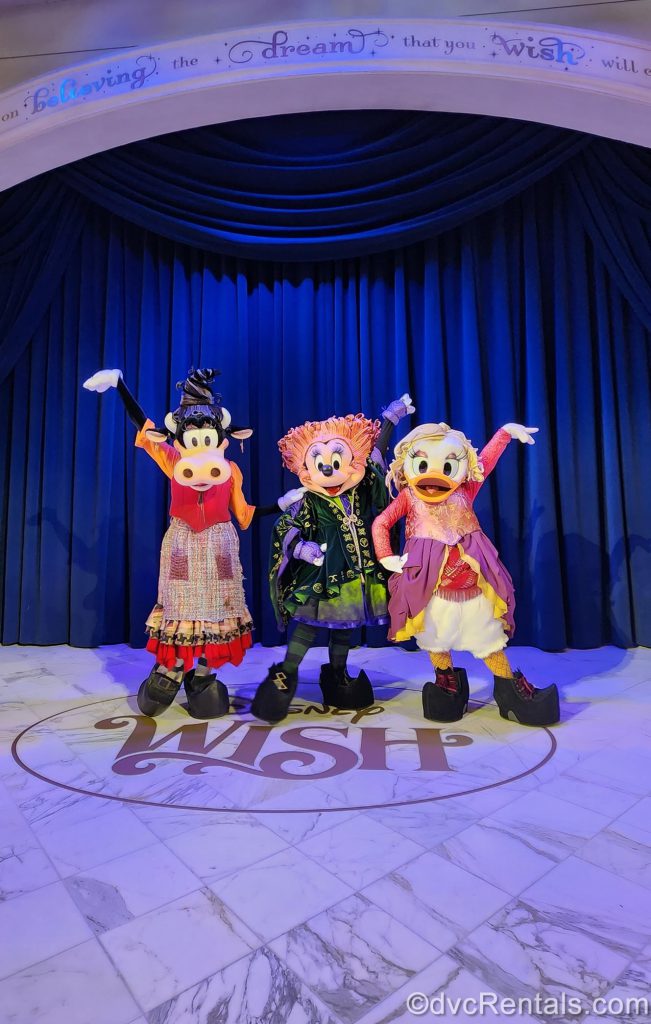 A photo of Minnie Mouse, Daisy Duck, and Clarabelle Cow as the Sanderson Sisters