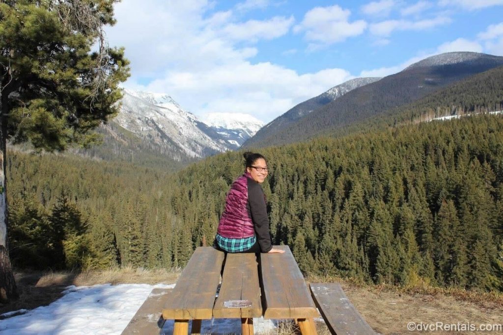 Mya sitting in front of mountains