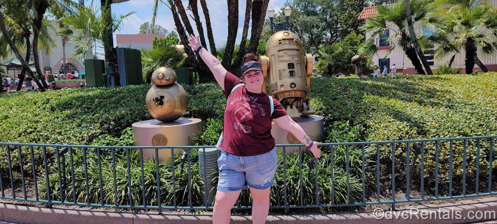 Kaitlyn standing in front of R2-D2 AND C-3PO statues