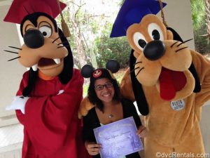 Mya with Goofy and Pluto in her graduation cap