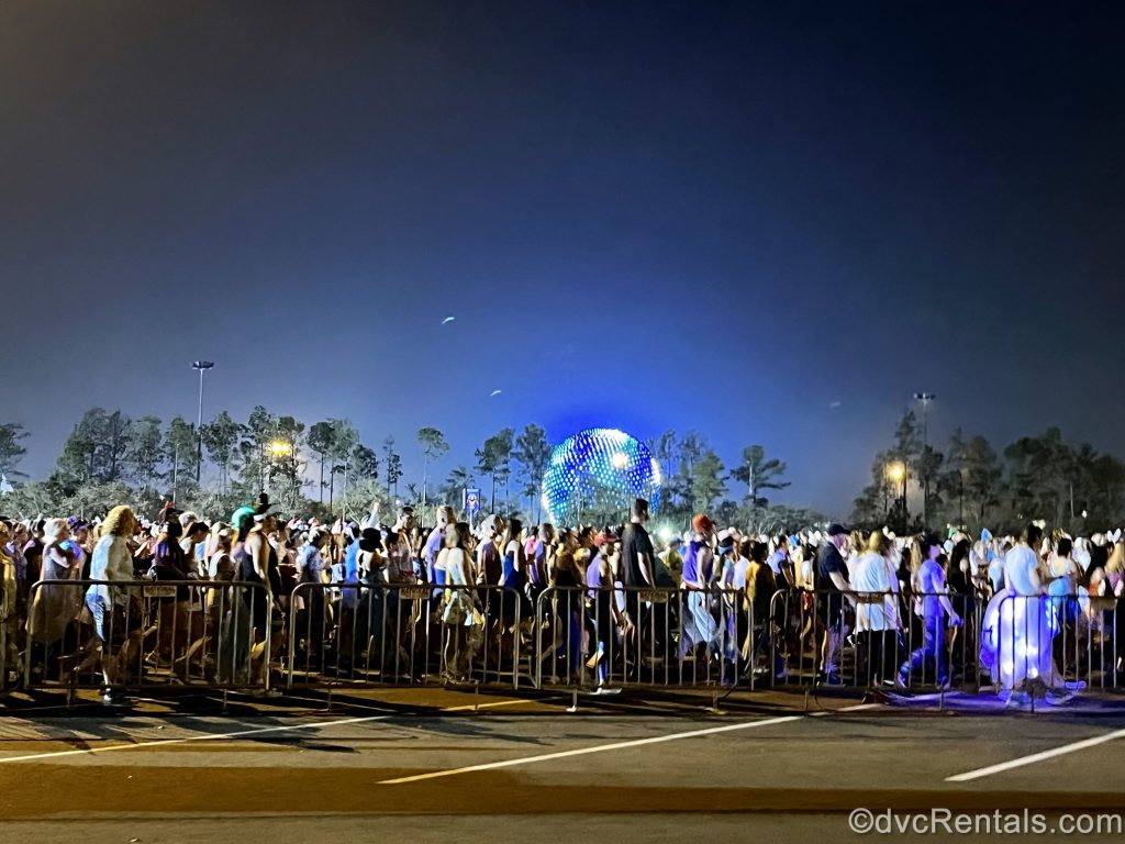 Spectators walking in front of Spaceship Earth