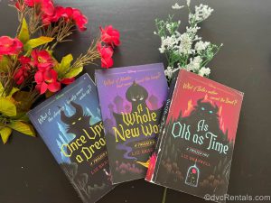 Three “A Twisted Tale” Books with Flowers in the background