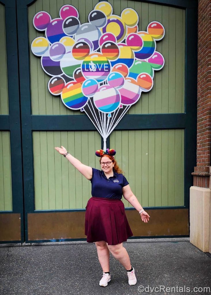 Kristen in front of the Pride Balloon Mural at Disney’s Hollywood Studios