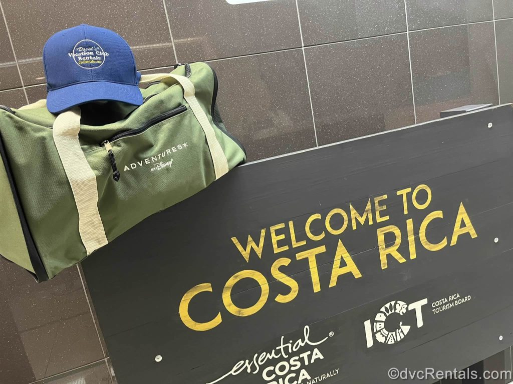 Sign that says “Welcome To Costa Rica” with a Duffle Bag and David’s branded Hat