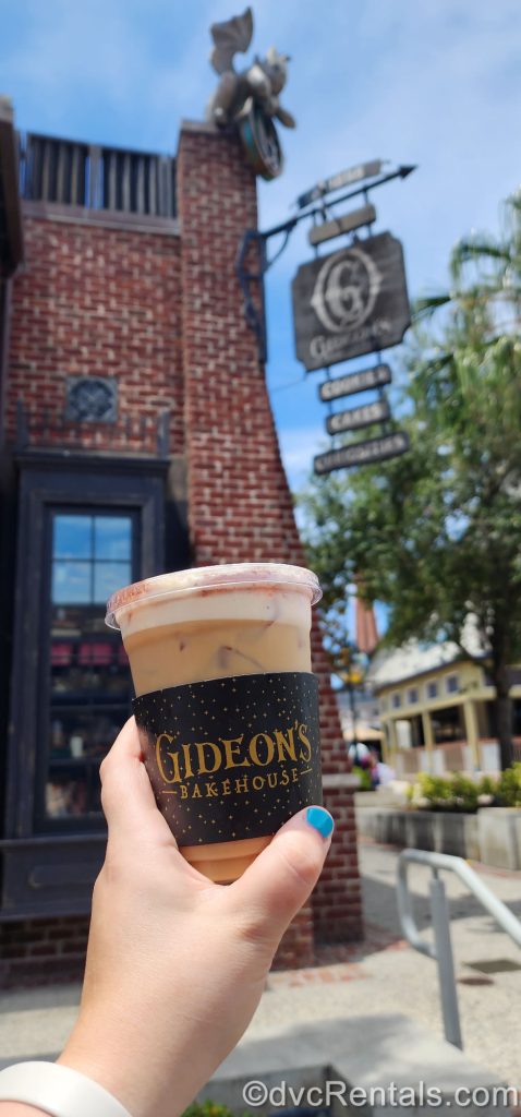 Peanut Butter Cold Brew in front of the sign at Gideon’s Bakehouse in Disney Springs