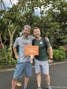 Two Adventures by Disney Guides in Costa Rica holding an Adventures by Disney Sign