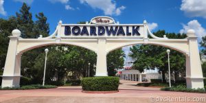 Disney’s Boardwalk Entrance. Large double archways made of white wood with the Disney’s Boardwalk Marquee up top.