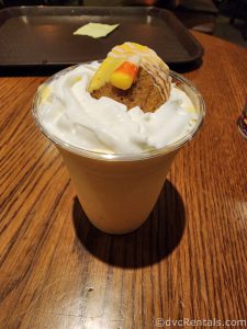 Candy Corn Milkshake topped with a piece of cornbread.