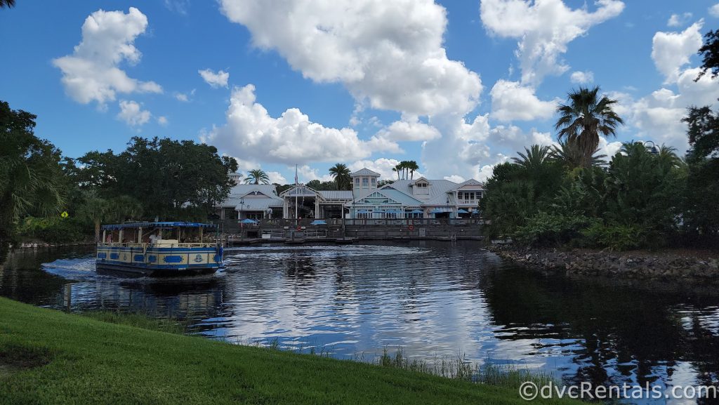 Back of Disney’s Old Key West Resort with a water taxi floating in the water in front.