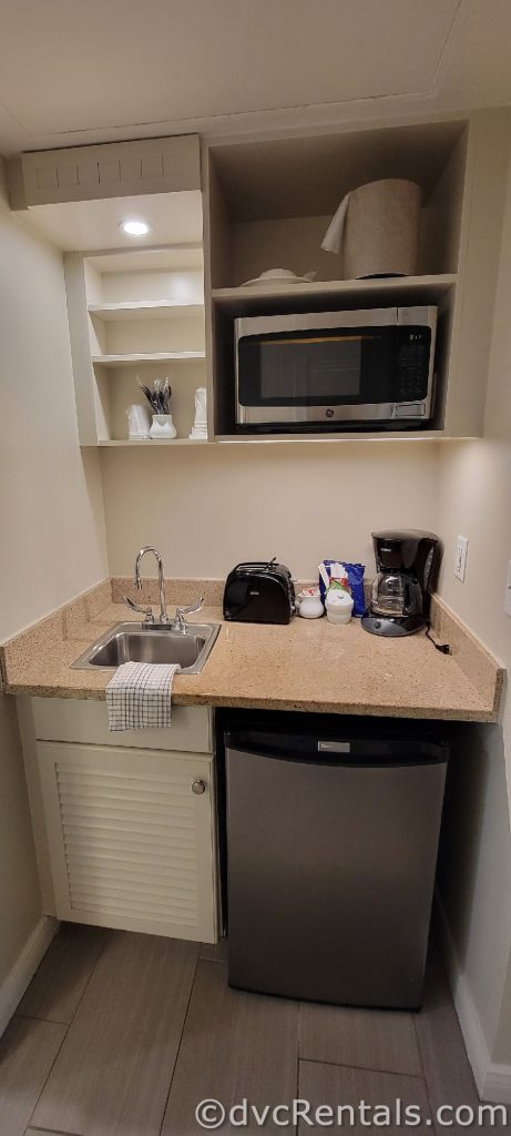 Kitchenette in the Old Key West Studio featuring a sink, mini fridge, coffee maker, and cabinets.