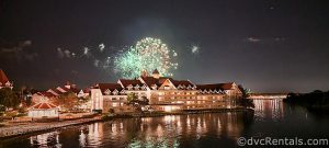 Exterior of Disney's Grand Floridian Resort and Spa at night with fireworks overhead.
