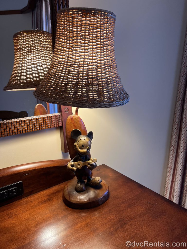Wooden lamp. The base of the lamp is carved into a statue of Mickey Mouse playing a ukelele.