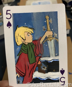 A painting of Arthur from the Sword in the Stone on a playing card.