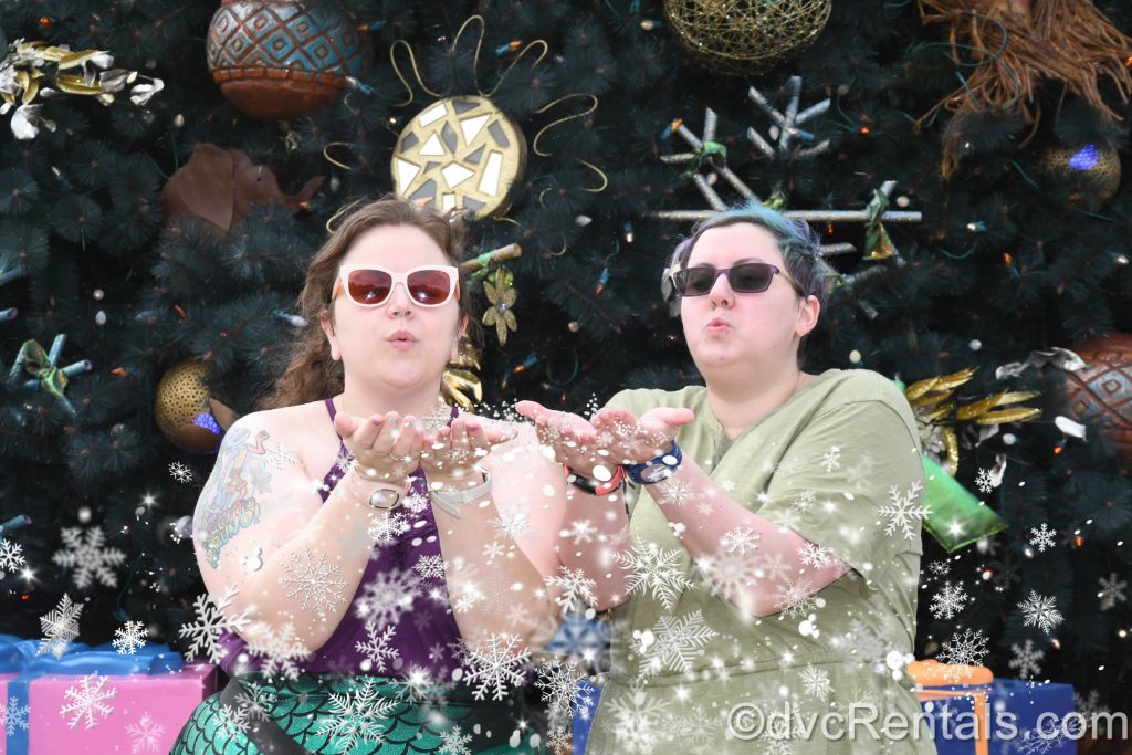 Kristen and her partner blowing snow in a Magic Photo at Walt Disney World.