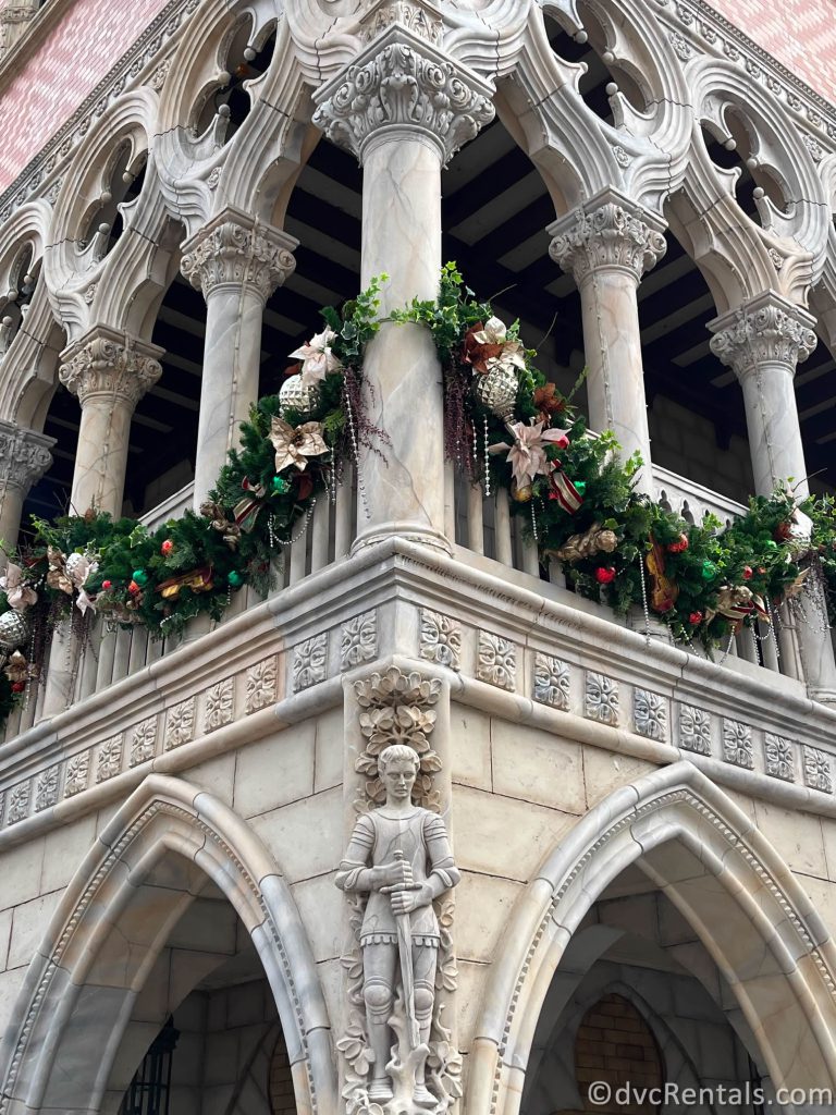Garland and ornaments hanging from a stone building in the Italy Pavilion.