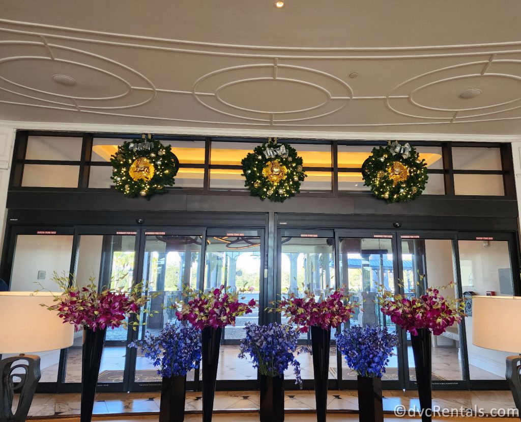 Three Wreaths hanging on glass doors at Disney's Riviera Resort.