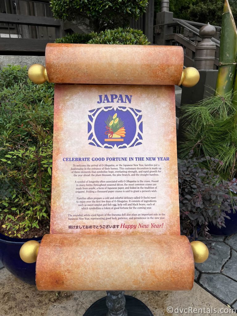 Scroll sharing the Japanese holiday traditions sitting in front of a garden.
