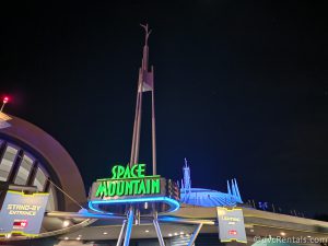 Space Mountain Sign at Night Glowing Green.