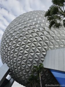 Exterior of Spaceship Earth during the day with clouds behind it.