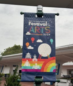 Festival of the Arts Sign hanging from a green pole.