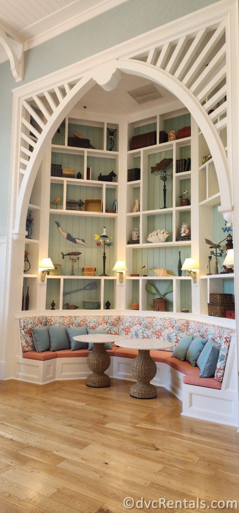 Seating Area tucked within a large white shelving unit in the Breezeway at Disney's Beach Club Villas.